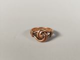 a close up of a gold ring on a white surface