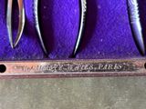 three pairs of scissors sitting in a purple box