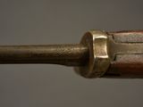 a close up of a gun with a brass handle