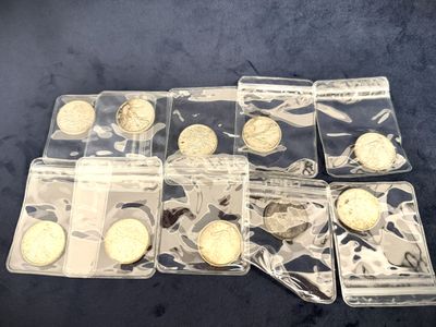 a lot of gold coins in plastic bags on the table