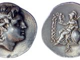 a close up of a silver coin with a woman on it