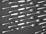 a lot of forks and spoons that are on the table