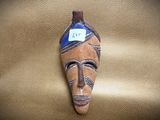 a mask on a leather surface with a tag on it