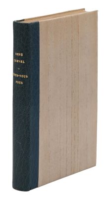 an old book sitting on top of a white surface