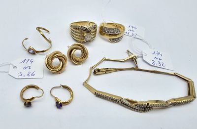 a lot of gold rings and bracelets on a table
