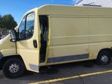 a yellow van that is parked in a parking lot