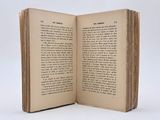 an open book on a white surface with a white background