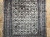 an old rug hanging on a wall in a room