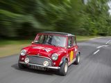 a small red car that is driving down the road