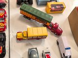 many toy cars and trucks on the table together