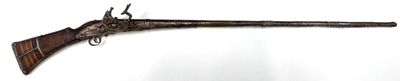 a very old gun that is hanging on the wall
