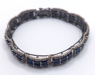an image of a close up of a bracelet on a white surface