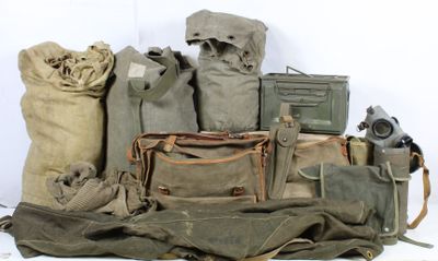 many bags of military items sitting on a white surface