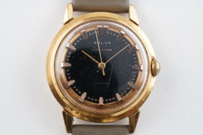une montre-bracelet en or avec un cadran noir