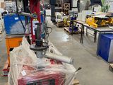 a picture of a machine in a warehouse with pallets of wood