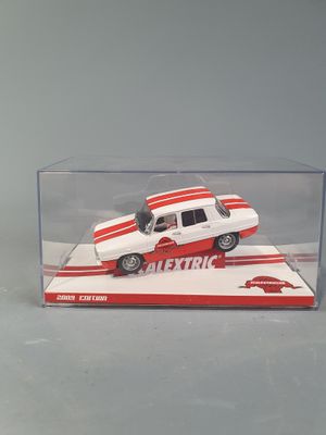 a white and red toy car in a clear display case