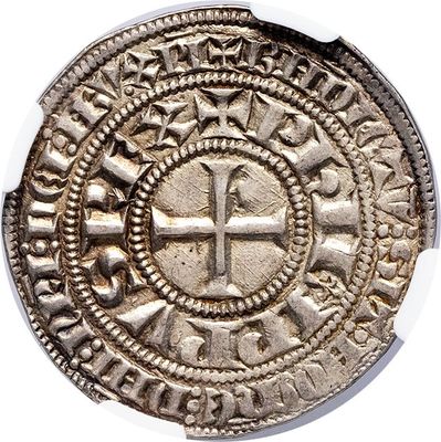 an old silver coin with a cross in the center on a white surface