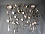 a lot of silver spoons and spoon spoons on a table