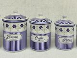 five blue and white canisters with purple flowers on them