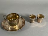 two cups and a saucer sitting on a table