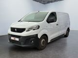 the small white van is parked in a large room