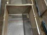 an overhead view of a large metal basket with a handle