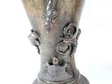 a silver vase with a dragon on it on a white background