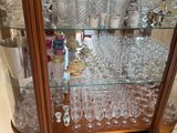 a glass display case with a lot of wine glasses on it
