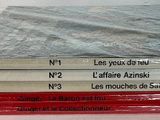 five books stacked on top of each other on a table