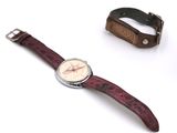 a watch that is sitting next to a wristband
