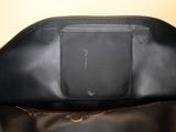 the inside of a black purse with a zipper on it