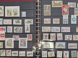many different stamps on a black binder on a table