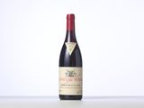 a bottle of red wine sitting on top of a table