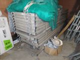 a pile of metal items in a room with a green cover