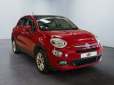 the red car is parked in a large room with a black floor