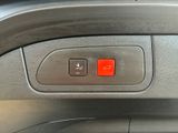 a close up of a red button on a car ' s dashboard