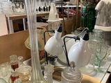 many glass vases and jars on the table