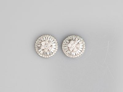 a pair of diamond and white gold earrings