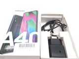 a box with a charger and a phone in it