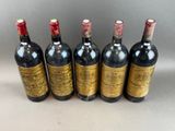 six bottles of wine lined up in a row on a table