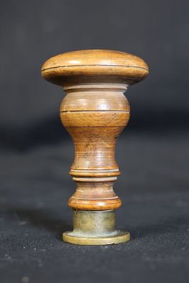 a close up of a wooden knob on a black background