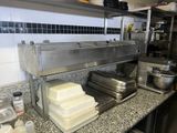 a counter with a bunch of plates and pans on it