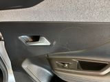 a close up of a car door handle with a hole in it