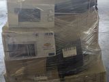 a stack of televisions sitting on a pallet in a warehouse