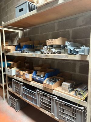 many boxes and bins on the shelves in the room