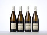 three bottles of wine sit next to each other on a table