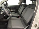 the interior of a car with the front seats folded down and a steering wheel in the center