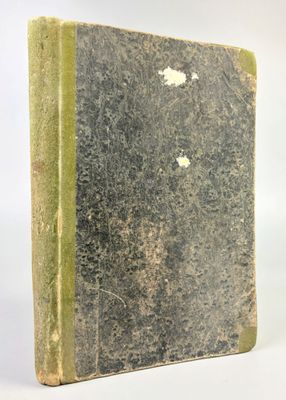 an old book that is sitting on a white surface