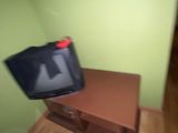 a small television sitting on top of a wooden table