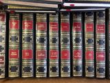 many books that are lined up on a shelf